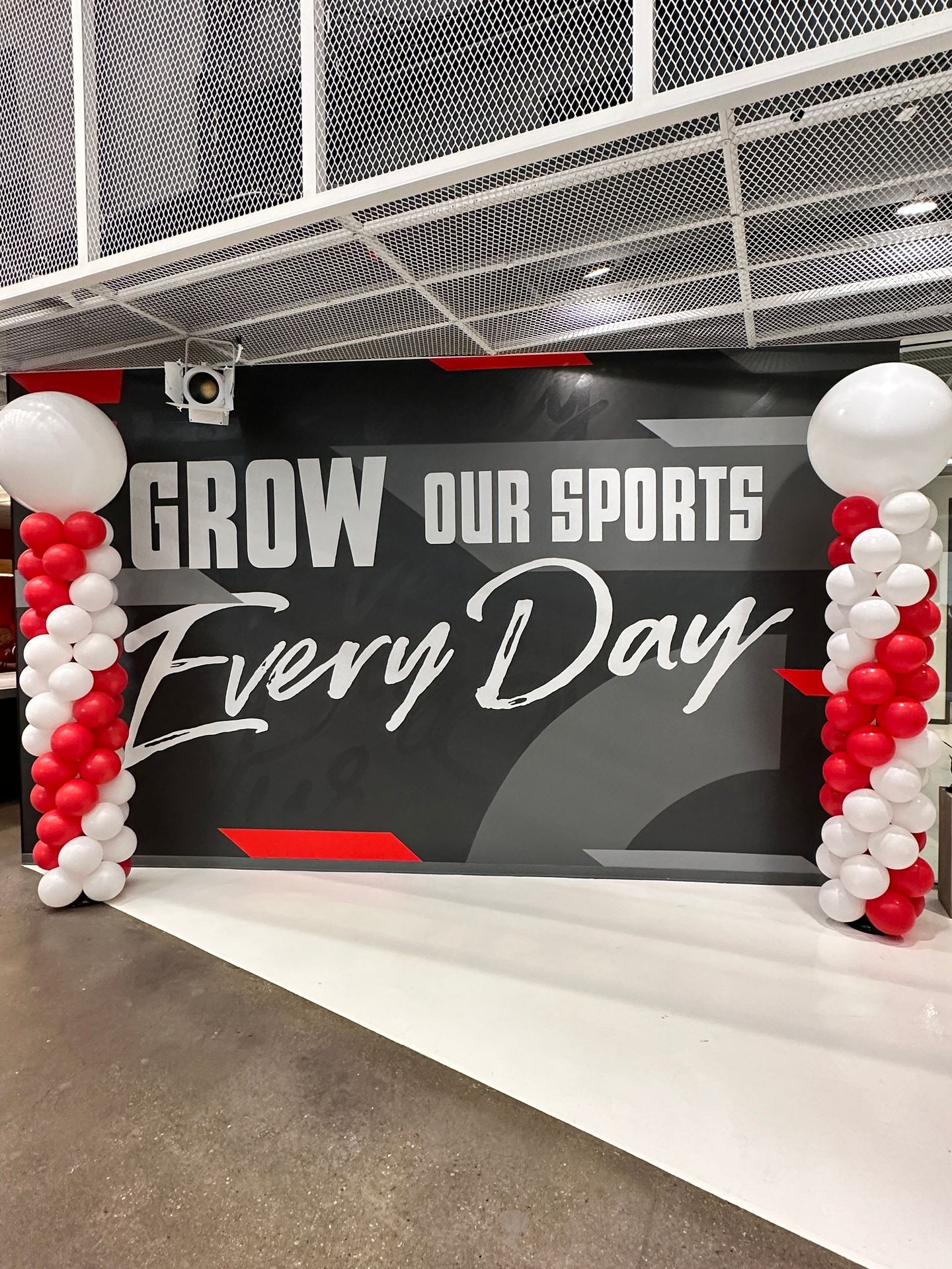 Professional balloon column in coordinated corporate colors standing tall at an Austin business event, featuring a structured cylindrical design with precision-aligned balloons by ATX Bubbles, creating an impressive vertical accent that defines the space