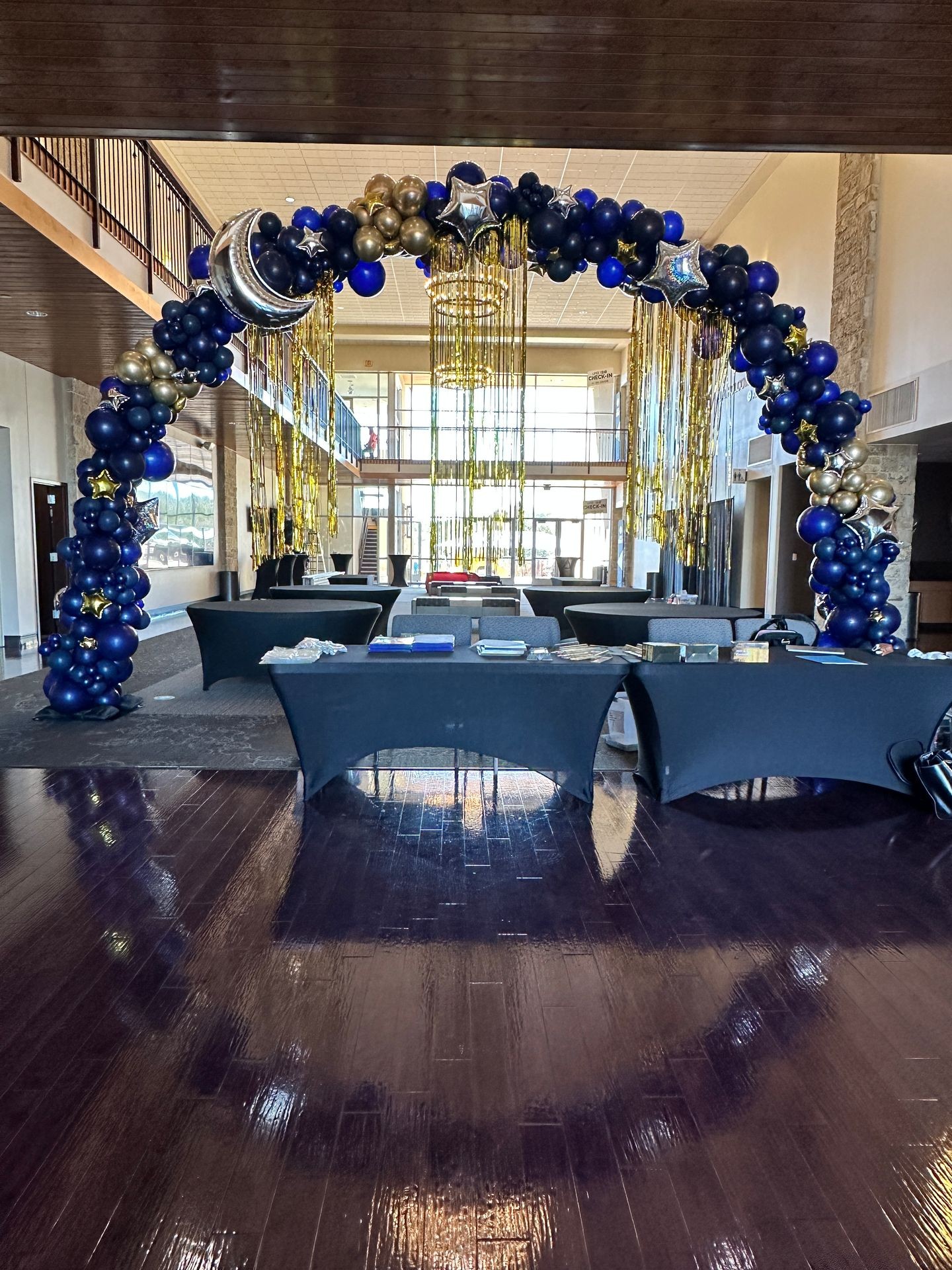 Elegant balloon arch in corporate brand colors marking the entrance to a professional event at an Austin venue, featuring organic design by ATX Bubbles with varying balloon sizes creating a welcoming gateway for attendees