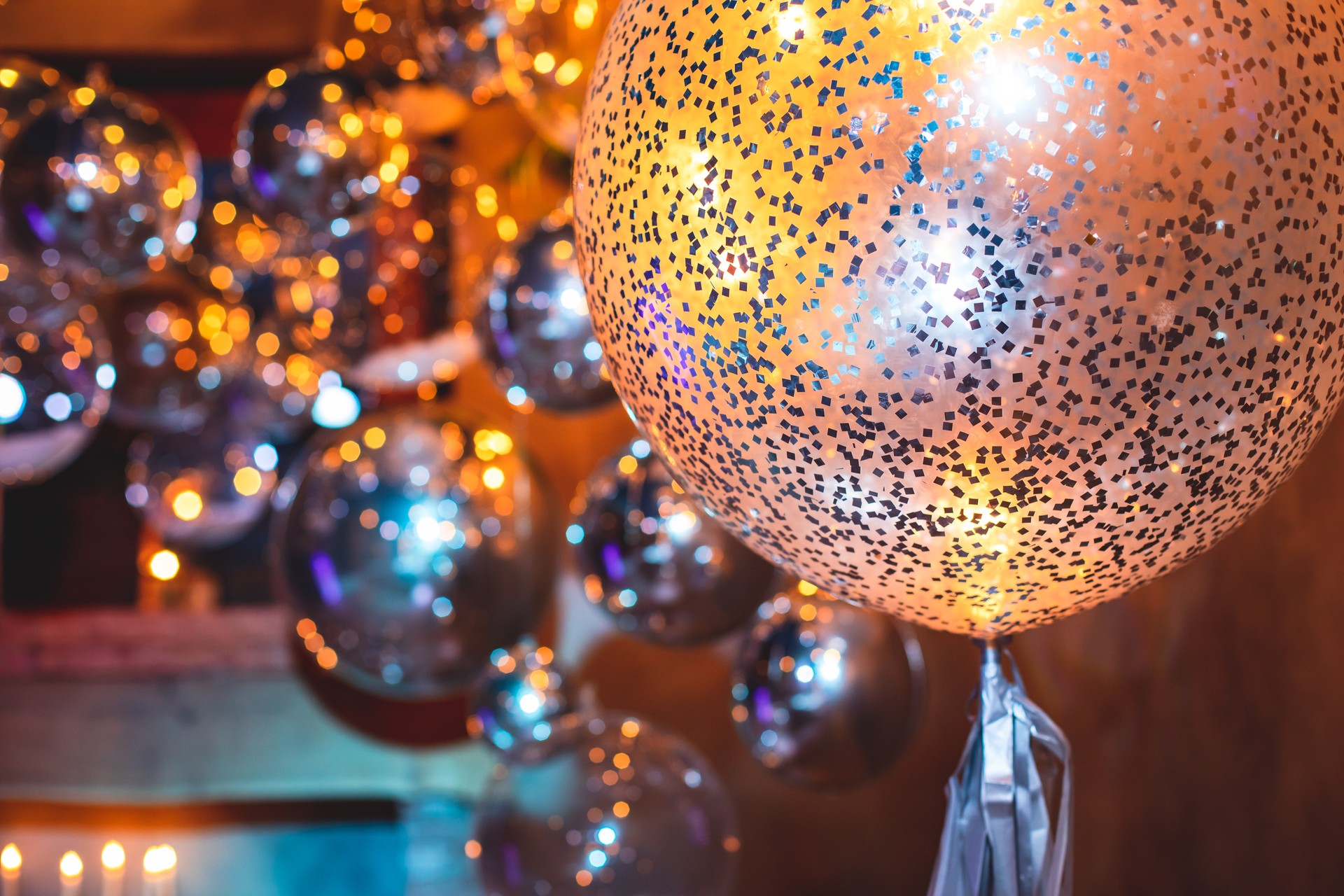 Decoration interior elements of restaurant venue banquet hall with multicoloured different helium balloons, on a indoor corporate event or wedding reception or birthday party celebration